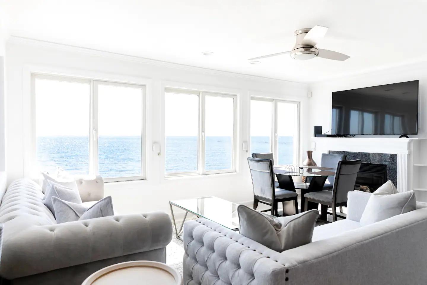 Open kitchen, dining, and living room space with seating for up to 12 guests