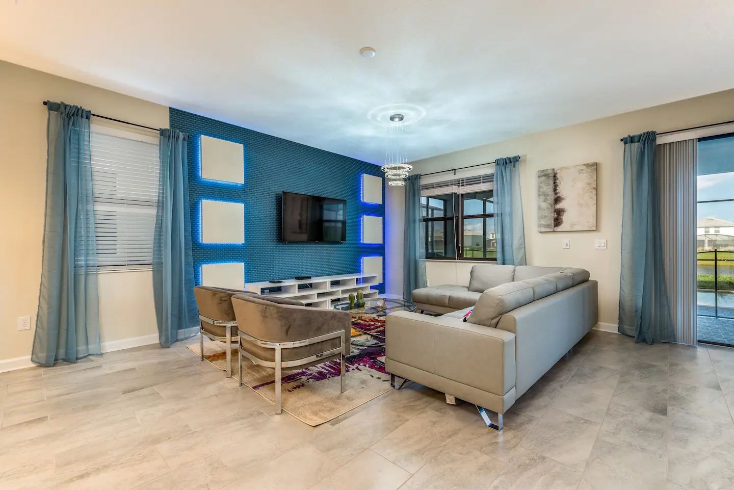 A 60" 4K SMART HDTV and a wide sofa are included in the living room.