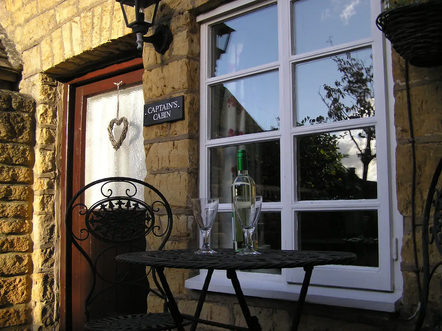 Drink a glass of wine in front of the cottage.
