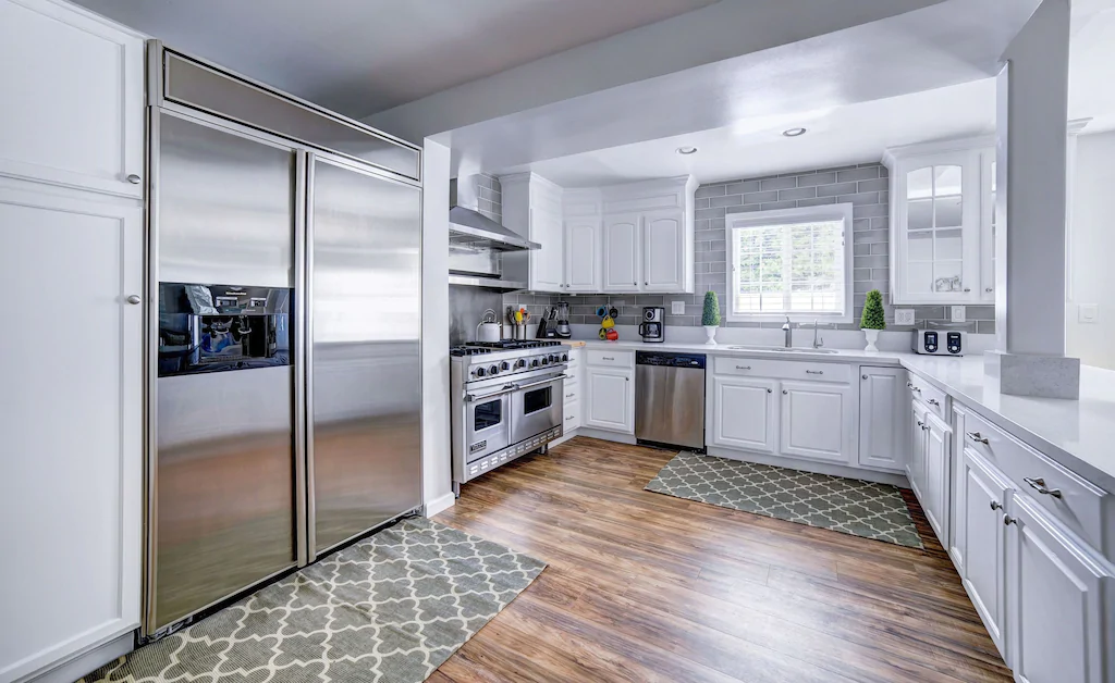 An open kitchen with numerous tiny appliances.
