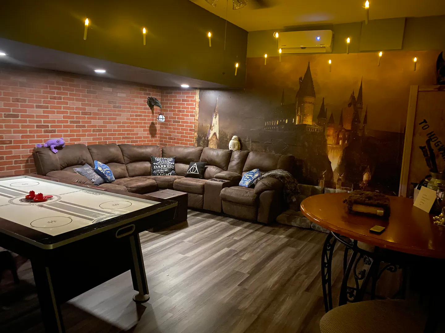 Custom Harry Potter game and media room complete with skee ball table, air hockey table/ping pong top, 75" smart TV, beverage cooler, and other amenities.