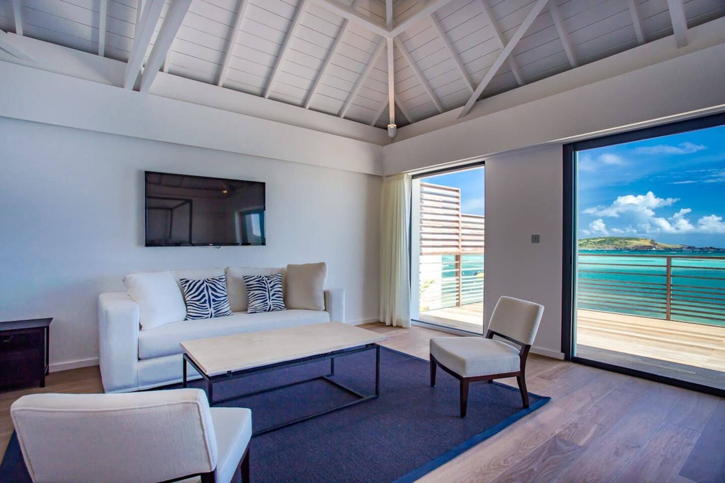 A stylish and sophisticated living room with contemporary furniture, elegant decor, and large windows allowing plenty of natural light.
